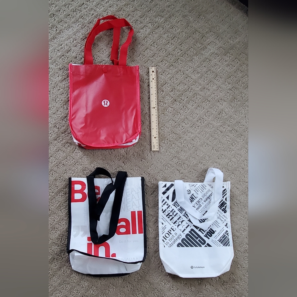 3 lululemon shopping bags.  Used to bring product home.